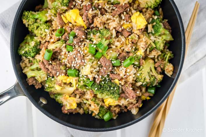 Beef and Broccoli Fried Rice in a pan with a wooden spoon.