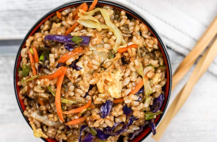 Healthy fried rice made with brown rice, eggs, cabbage, carrots, ginger, and garlic.
