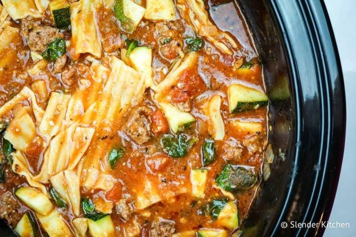 Healthy Slow Cooker Lasagna Soup with noodles, zucchini, and ground beef in a slow cooker.