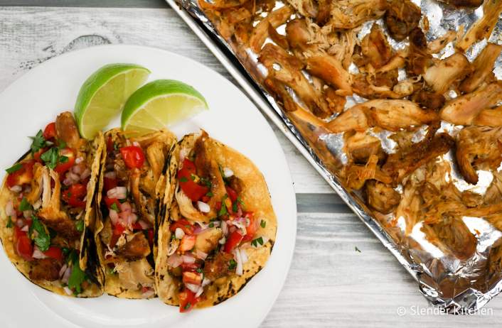 Slow Cooker Chicken Carnitas with corn tortillas and lime juice.