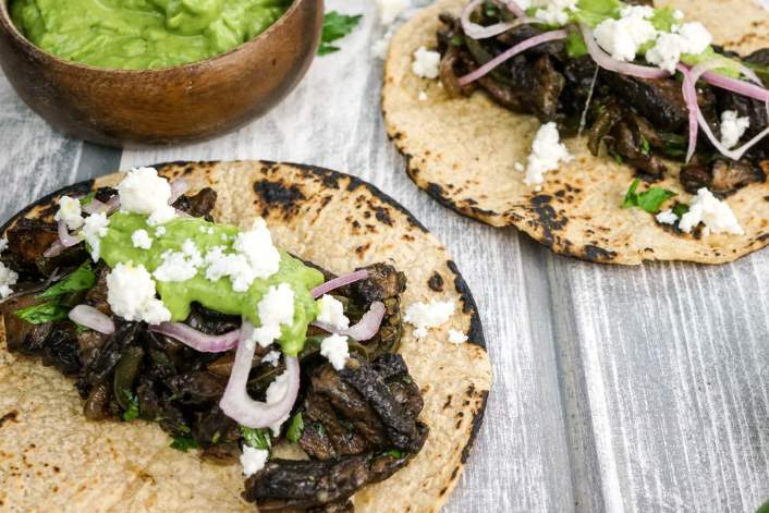 Portobello and Poblano Tacos topped with avocado herb salsa and queso fresco.