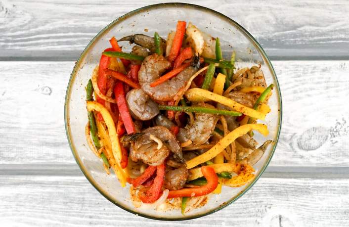 Shrimp mixed with homemade fajita seasoning for One Pan Shrimp Fajitas.