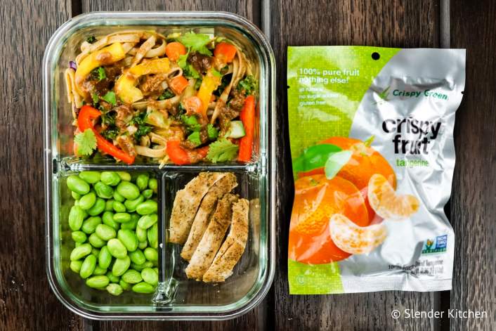 Bistor box with dried tangerines, Asian pasta salad, and edamame.