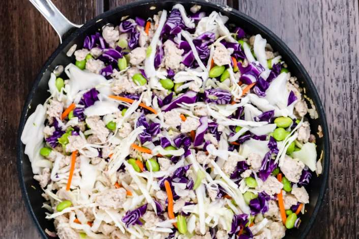 Egg Roll Bowls in the skillet with cabbage, carrots, and onions.