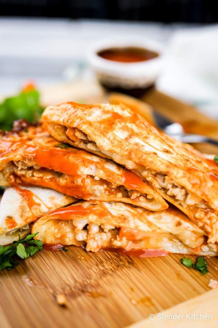 Easy buffalo chicken quesadilla stacked on top of each other.