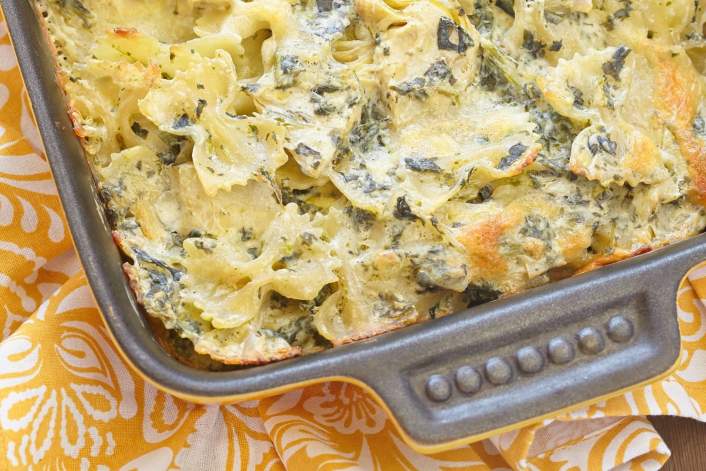 Weight Watchers Spinach Artichoke Pasta with a yellow floral napkin.