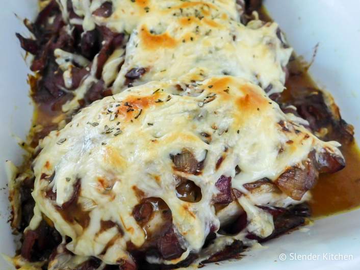 French Onion Soup Chicken on a plate with shredded melted cheese.