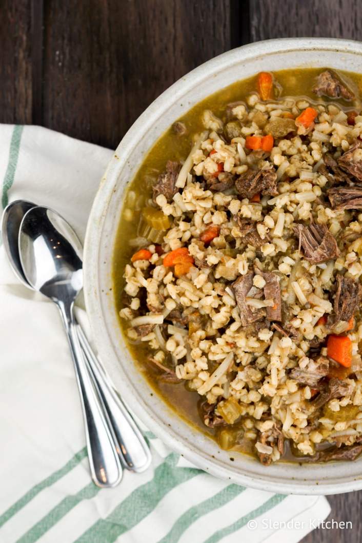 Weight Watchers Beef and Barley Stew in a bowl with two spoons.