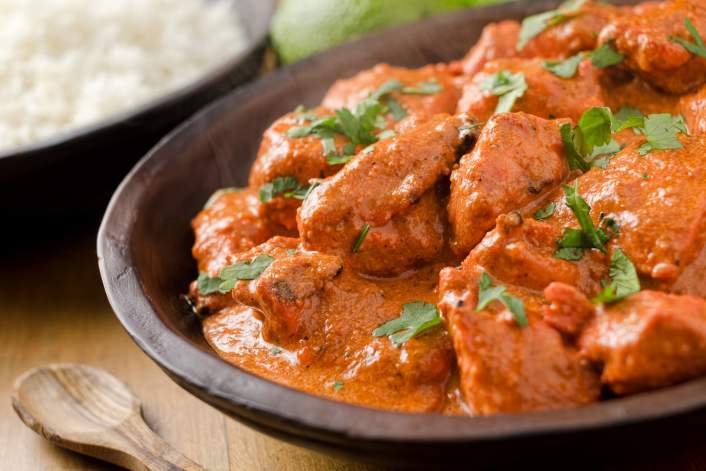 Weight Watchers Slow Cooker Butter Chicken in a bowl with cilantro.