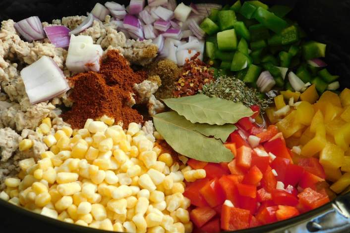 Weight Watchers Chicken Chili in a slow cooker with peppers, onions, and tomatoes.