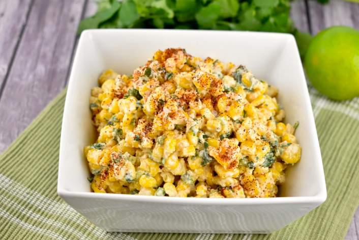 Healthy Mexican Street Corn on a bowl with a green napkin.