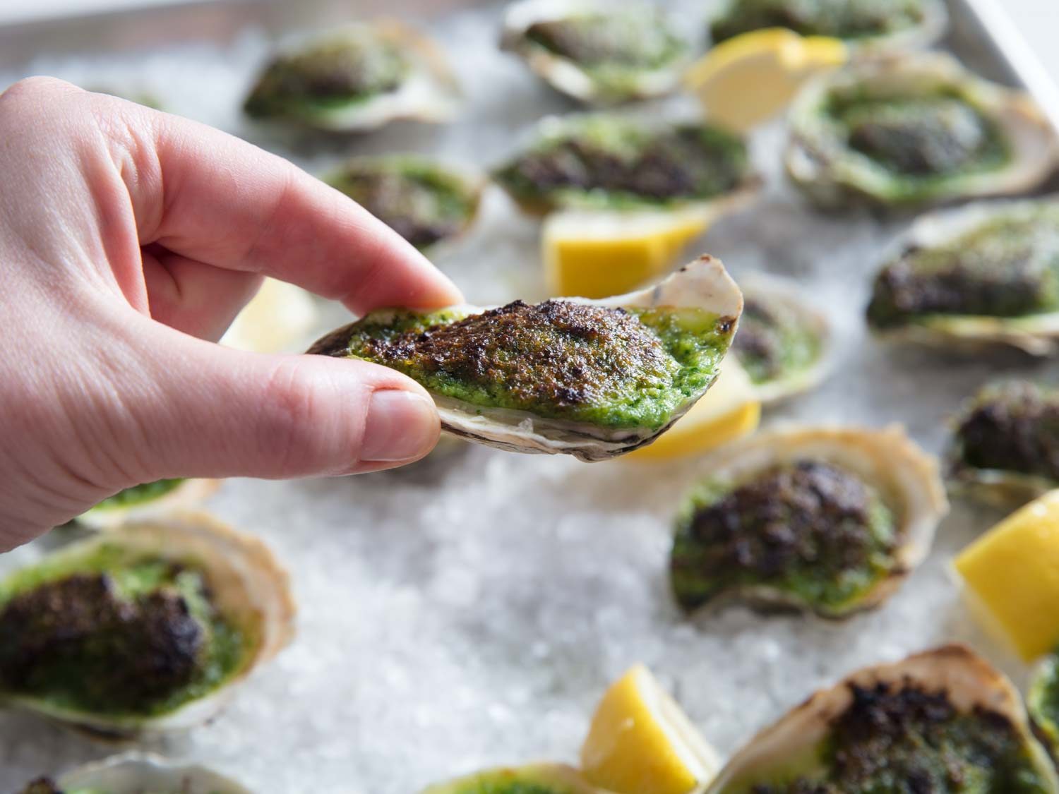 Holding a finished Rockefeller oyster.