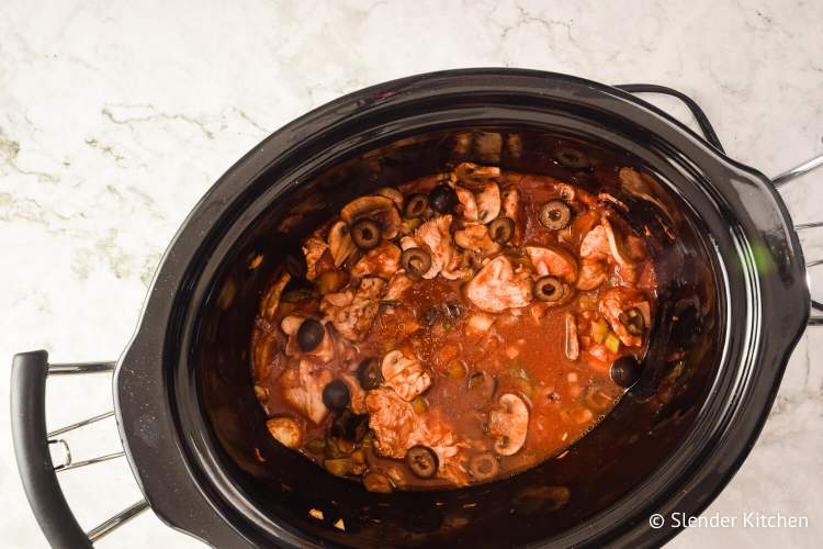 Crockpto chicken cacciatore in the slow cooker with peppers, onions, mushrooms, and tomatoes.