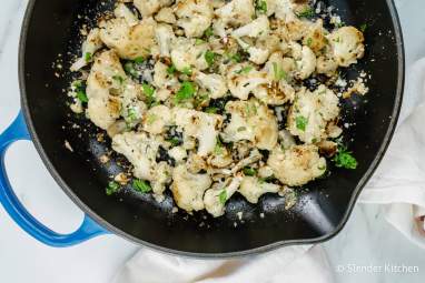 Garlic Parmesan Roasted Cauliflower in a skillet with fresh parsley.