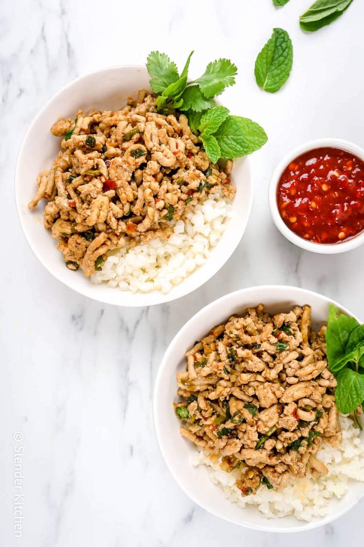 Chicken Larb made with ground chicken, soy sauce, garlic, and chili paste in two bowls with cauliflower rice.