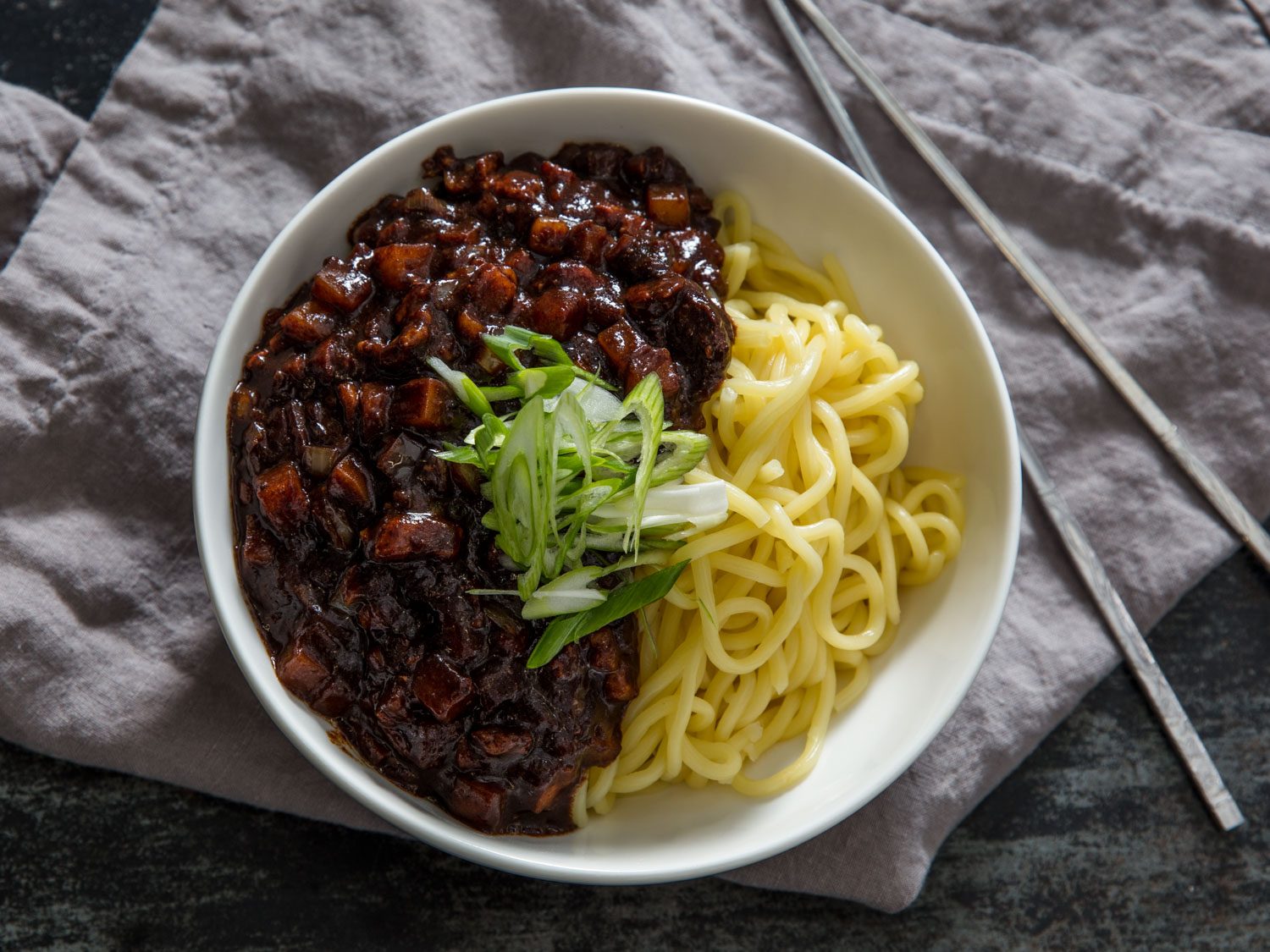 Overhead shot of a bowl of jjajangmyeon (wheat noodles and black bean sauce)