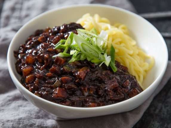 Close-up of a bowl of jjajangmyeon (wheat noodles with black bean sauce)