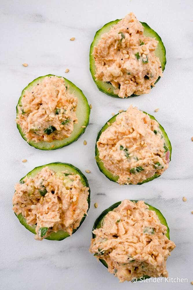 Spicy tuna salad with Sriracha and soy sauce on cucumber slices.