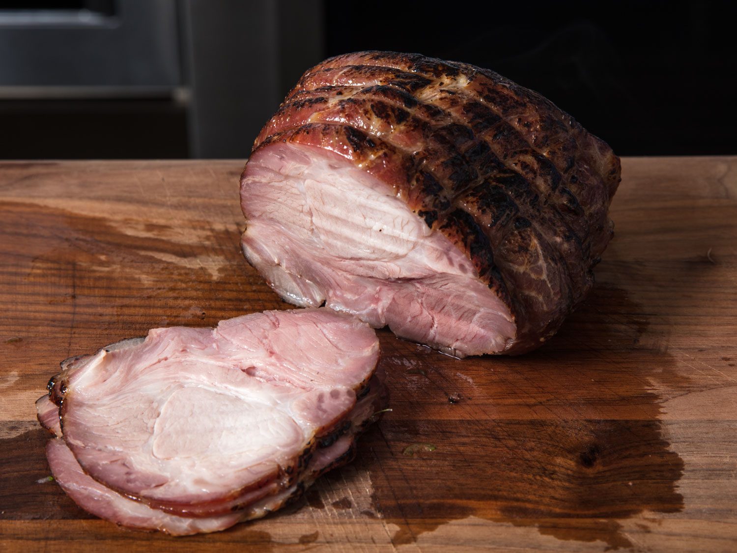 Pork shoulder roast next to slices carved off roast