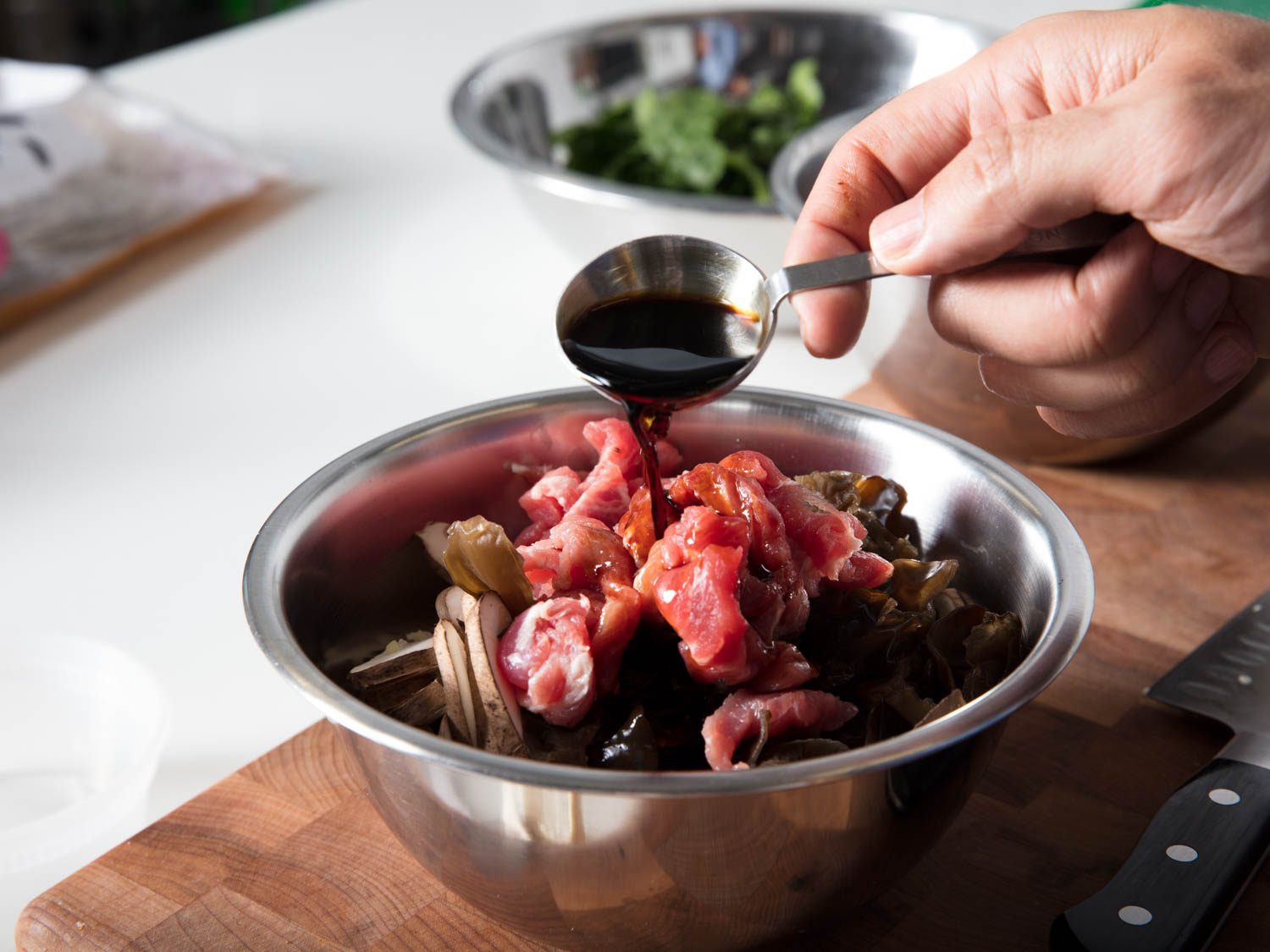 Marinating the pork and mushrooms for japchae