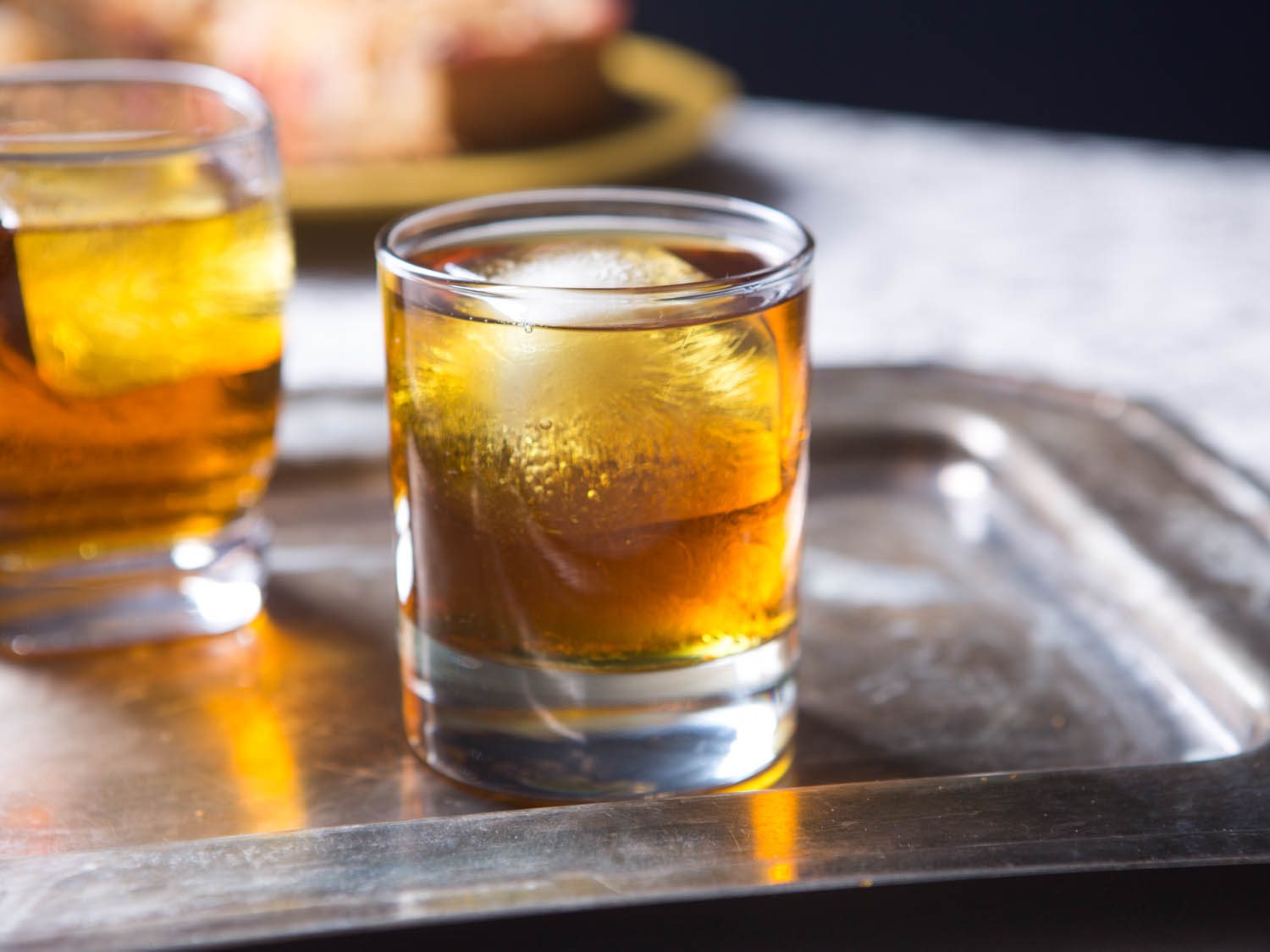 Old Fashioned cocktails in glasses on a silver tray