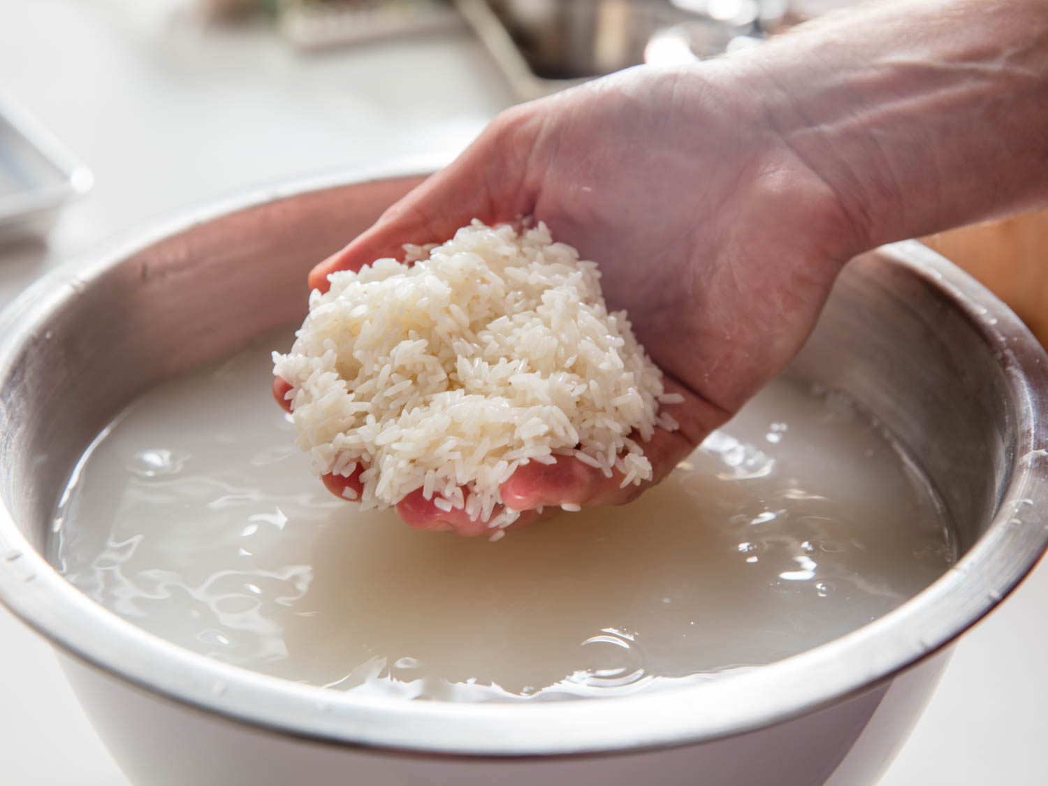 Soaking glutinous rice prior to cooking.