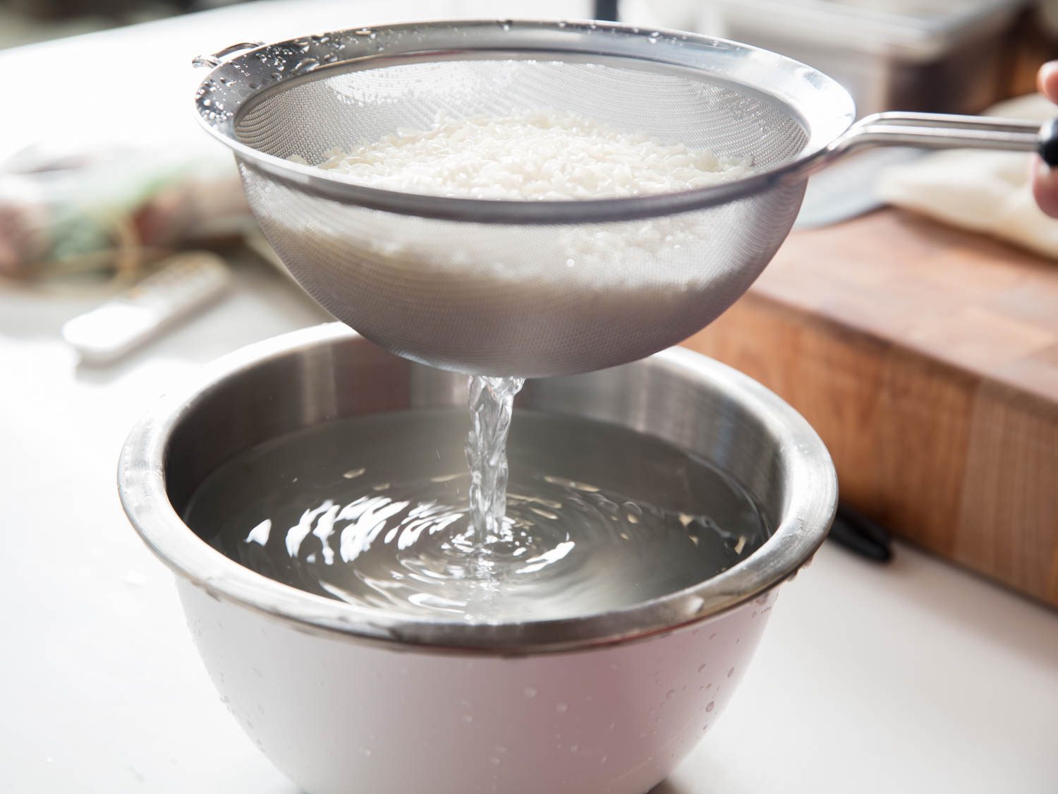 Rinsing sticky rice to get rid of excess starch.