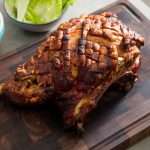 Roasted porcelet (pork shoulder) on a wooden cutting board