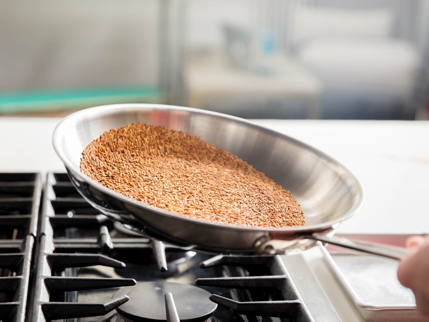 Tossing toasted rice in a skillet