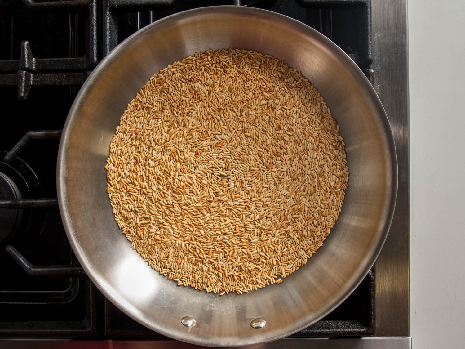 Overhead shot of toasting glutinous rice in a skillet.