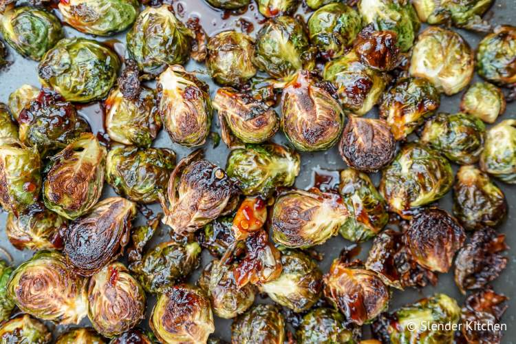 Crispy Asian Brussels sprouts with an Asian glaze on a baking sheet.