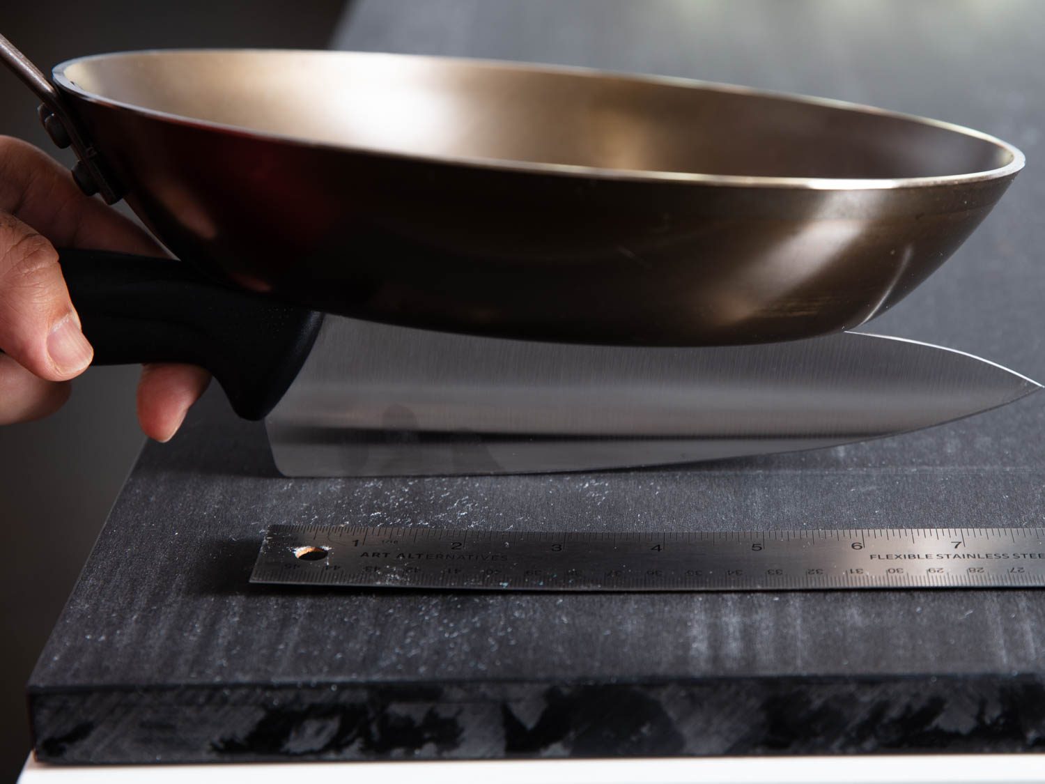 This photo shows how we rigged up our test of plastic cutting board durability by using a consistent pressure and stroke length