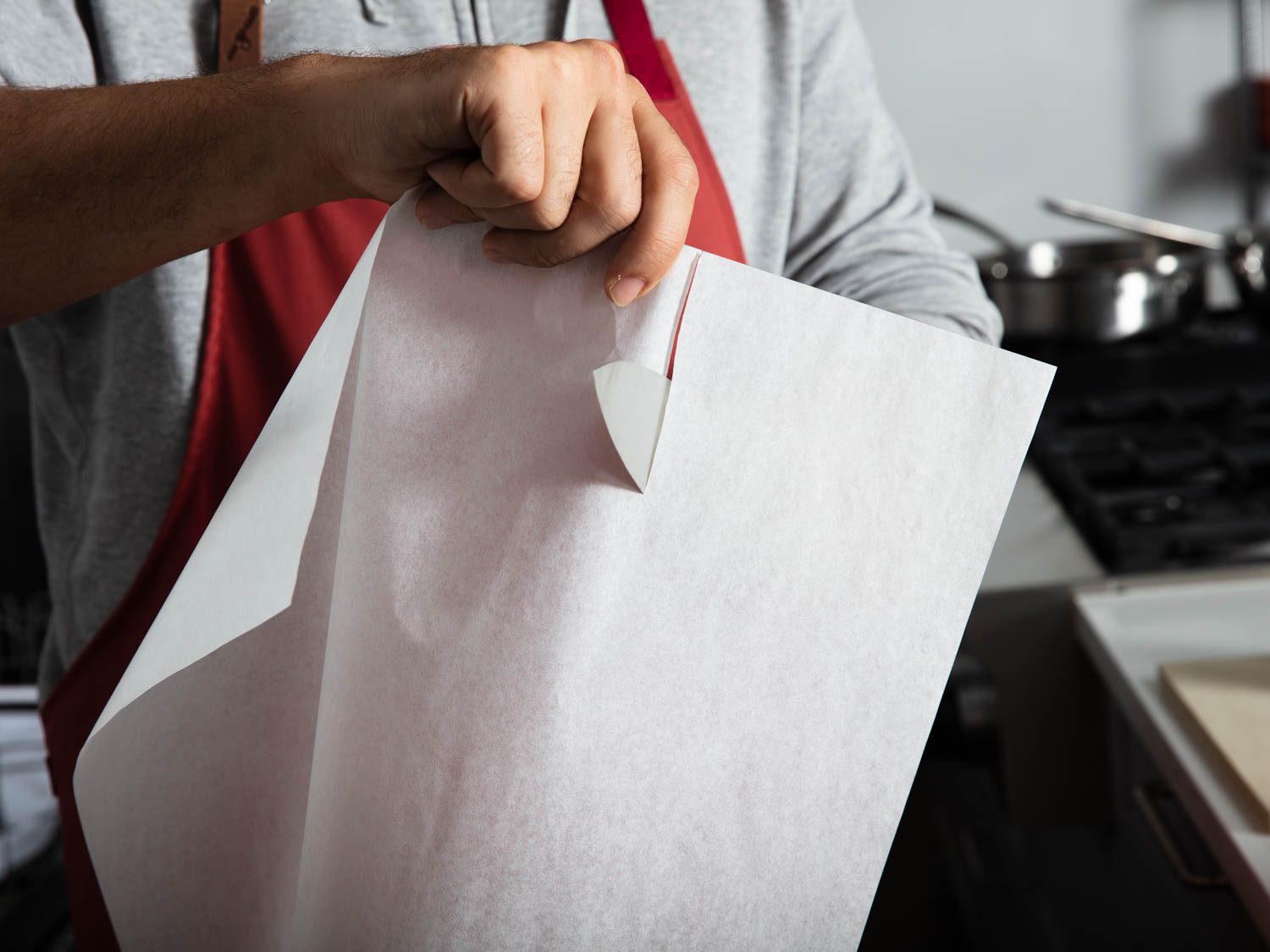 Slicing parchment paper tests how dull a blade has become after being used on a plastic cutting board.