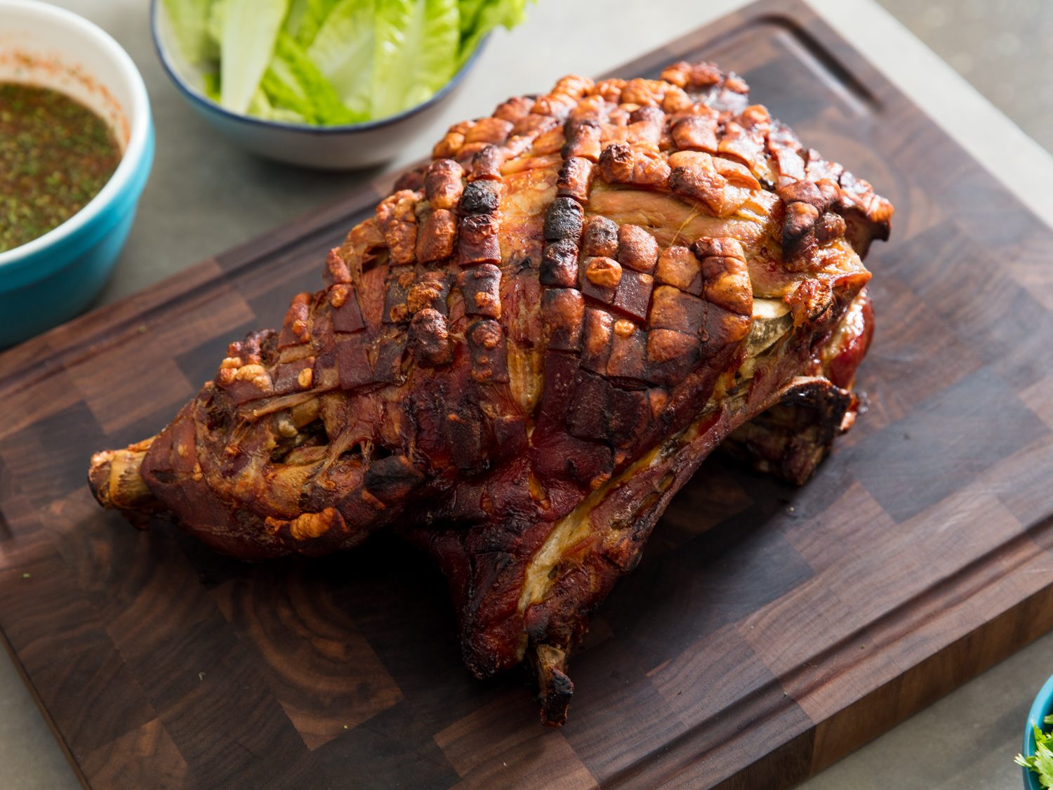 Roasted porcelet (pork shoulder) on a wooden cutting board