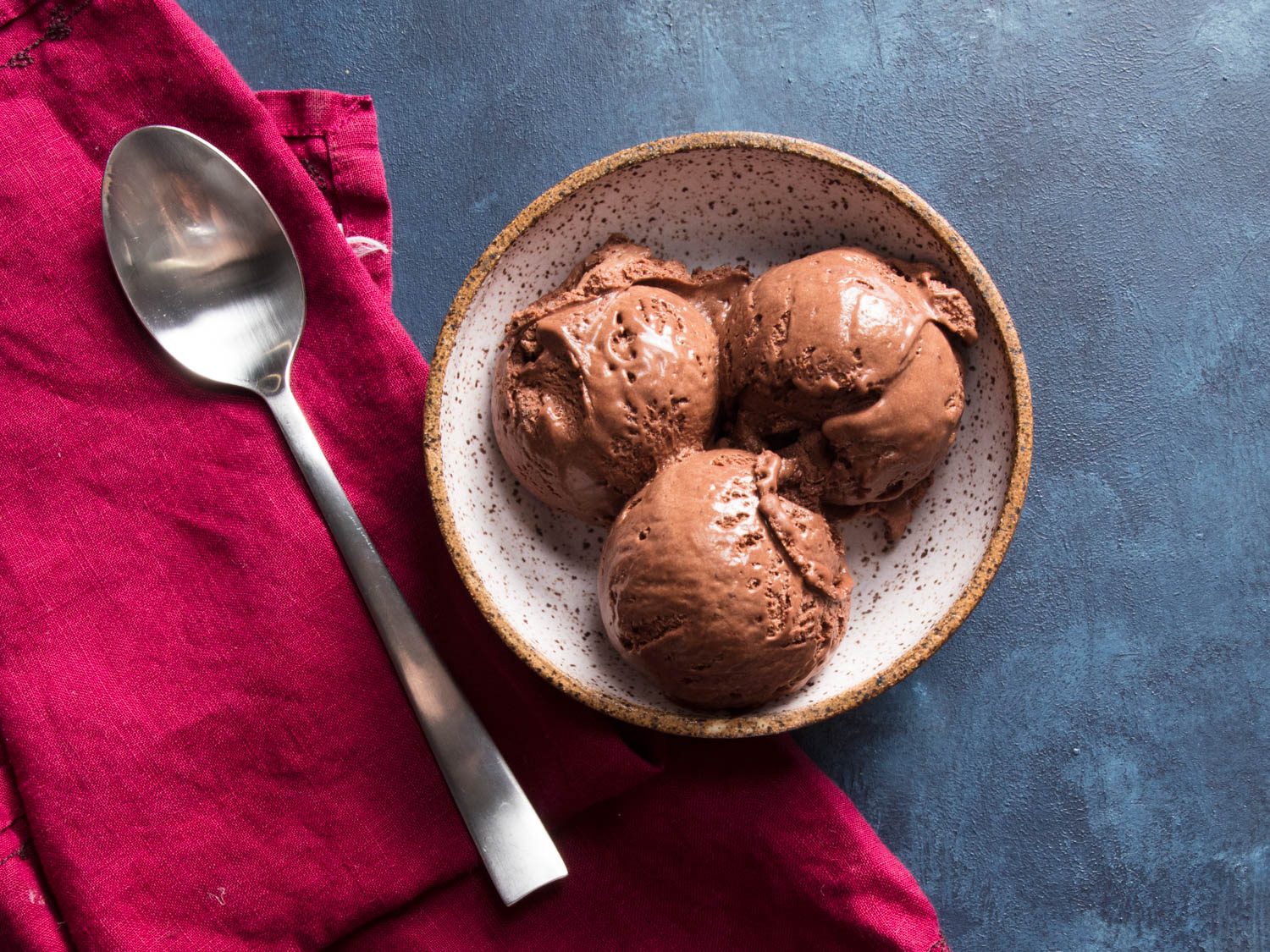 overhead shot of three scoops of chocolate ice cream in a dish