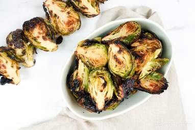Grilled Brussels Sprouts Grilled Brussel Sprouts on a skewer and in a bowl with grill marks.