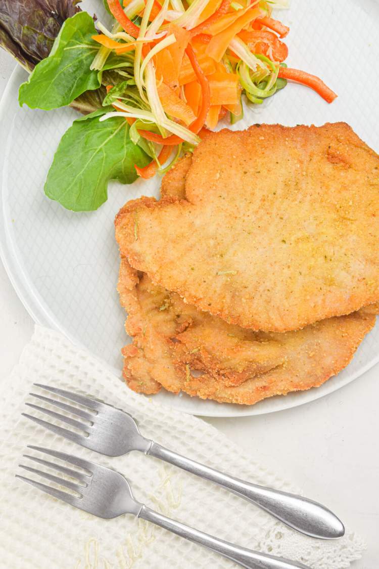 Crispy pork with a honey mustard breadcrumb coating alongside a simple salad.