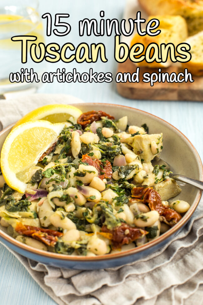 Portion of Tuscan beans in a bowl with lemon slices.