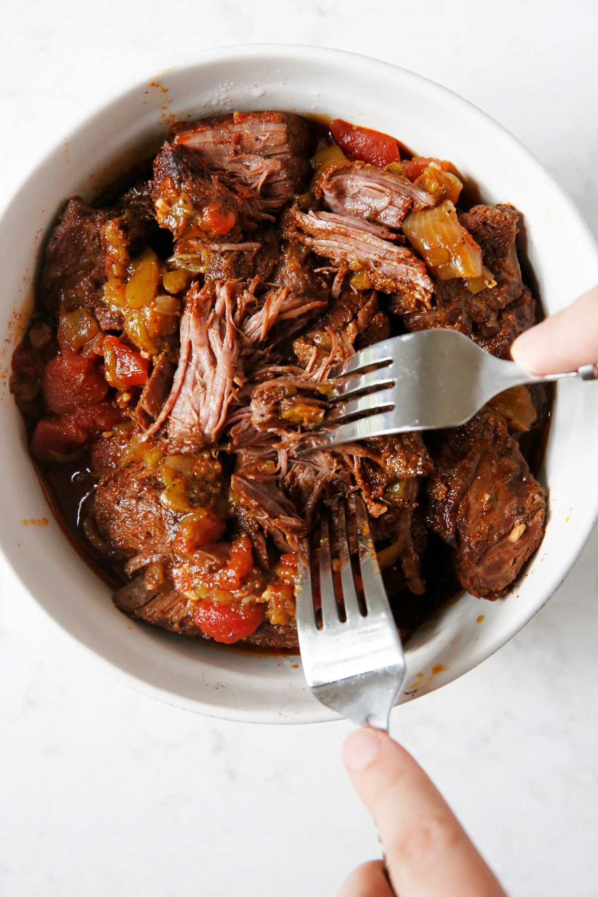 shredded beef barbacoa meat with a fork