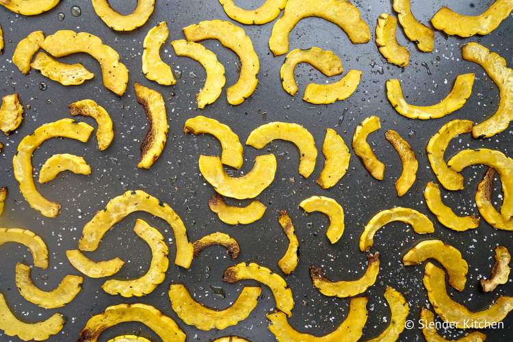 Roasted delicatat squash on a sheet pan.