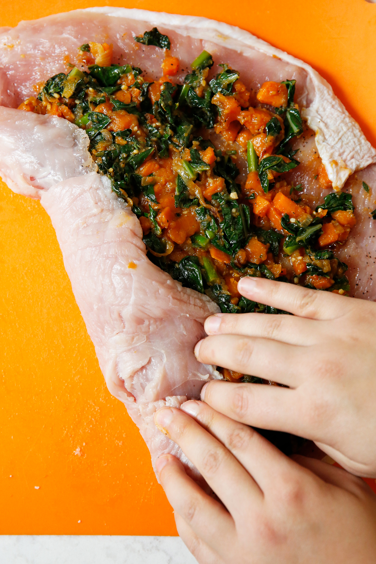 Rolling up a stuffed turkey breast