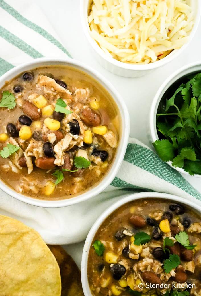 Weight Watchers Taco soup in a bowl with beans, chicken, and cheese.