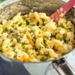 One pot creamy veggie pasta in a saucepan topped with chives.