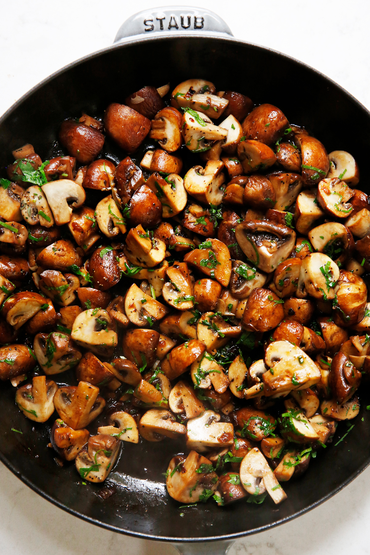 Garlic mushrooms with tons of herbs in a saute pan
