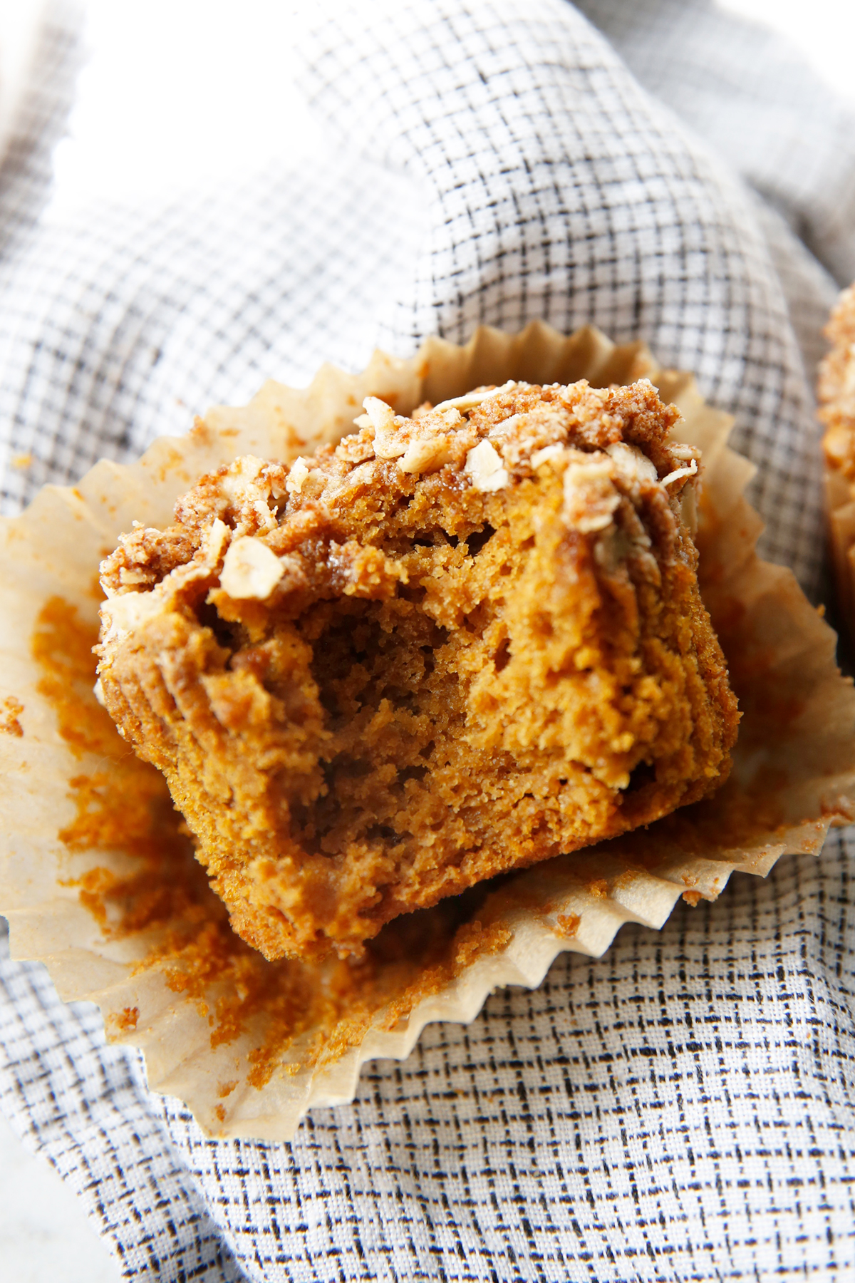 A gluten free pumpkin muffin with a bite taken out of it