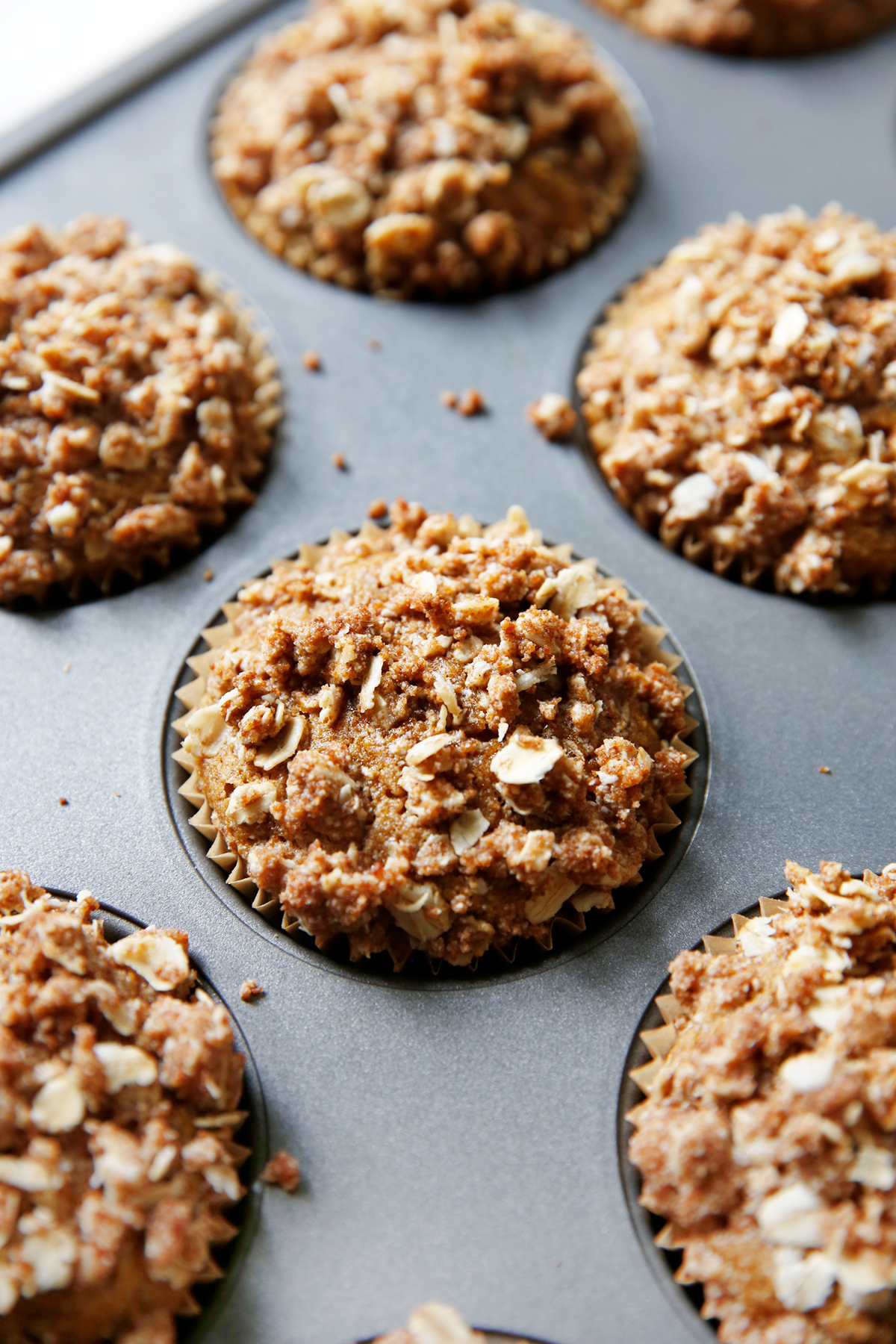 Muffin tin filled with pumpkin oat muffins