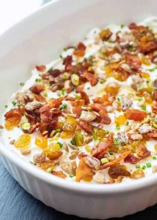Top 7-layer goat cheese dip with figs and raisins
