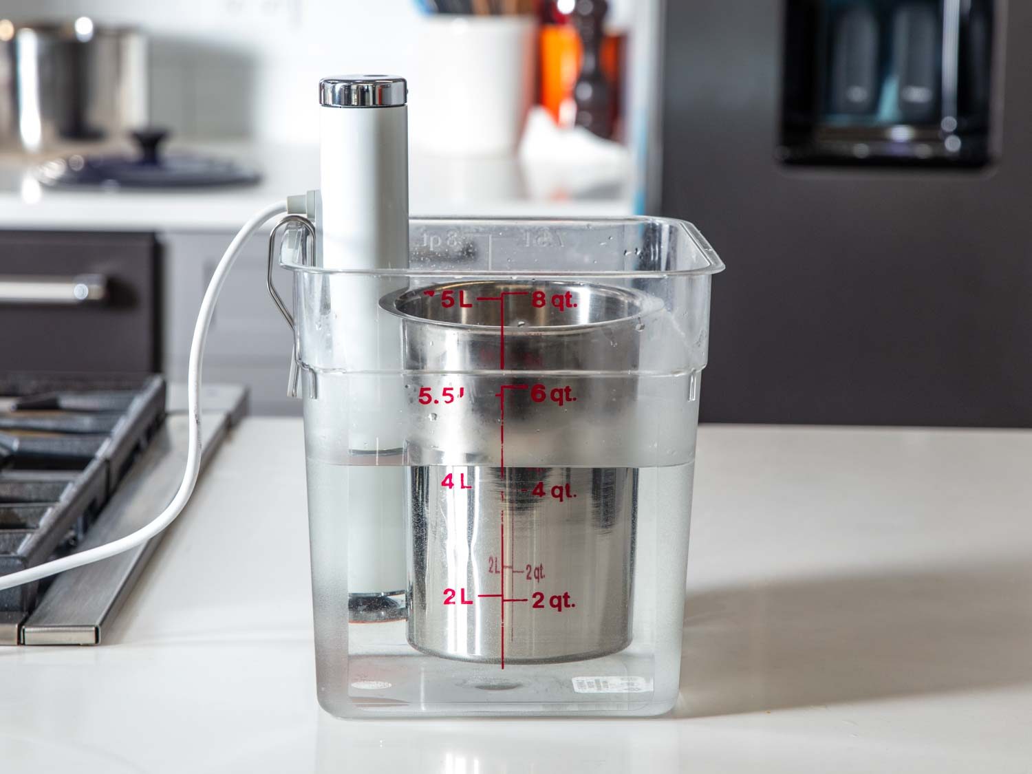 This photo shows an immersion circulator setup with a metal bain marie holding gravy: the immersion circulator creates a hot-water bath so the gravy stays warm in it