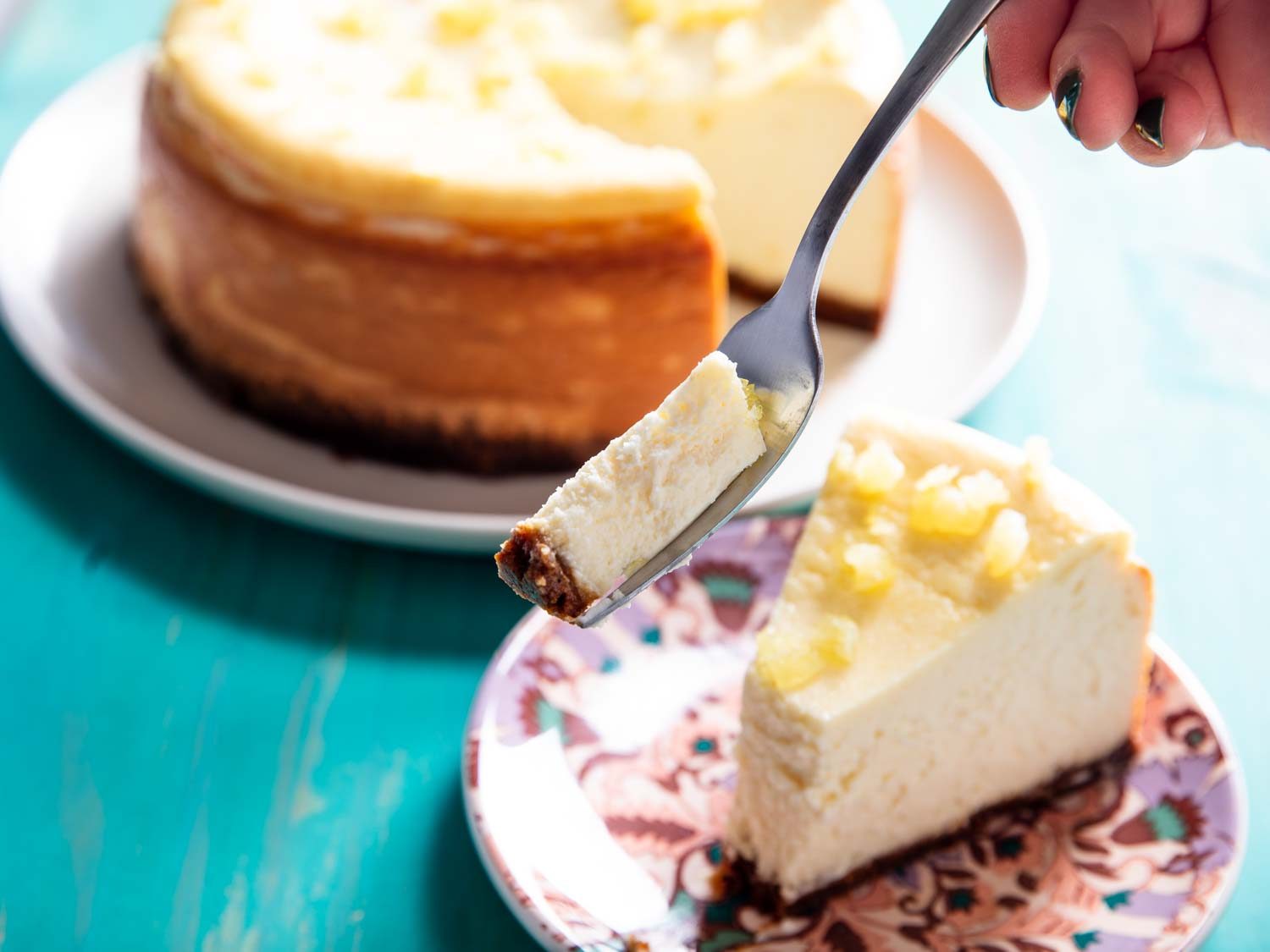 Taking a bite from a slice of lemon cheesecake