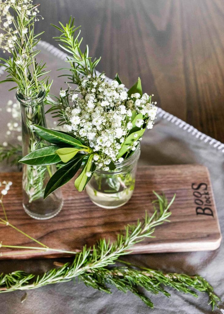 babys breath in mason jar on wood cutting board